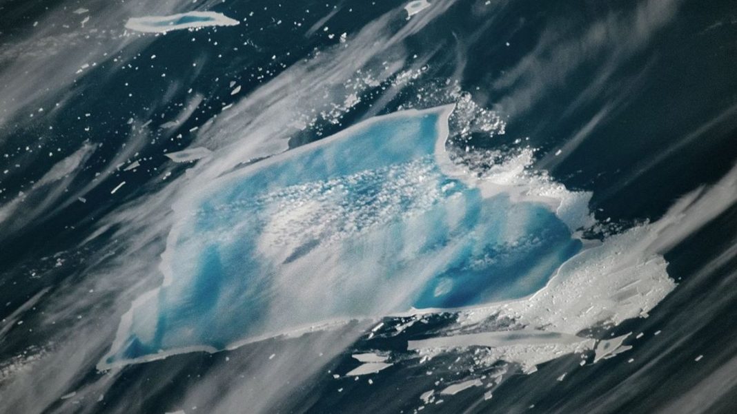 A 40-year-old iceberg is turning a stunning blue as it approaches its final melt.
